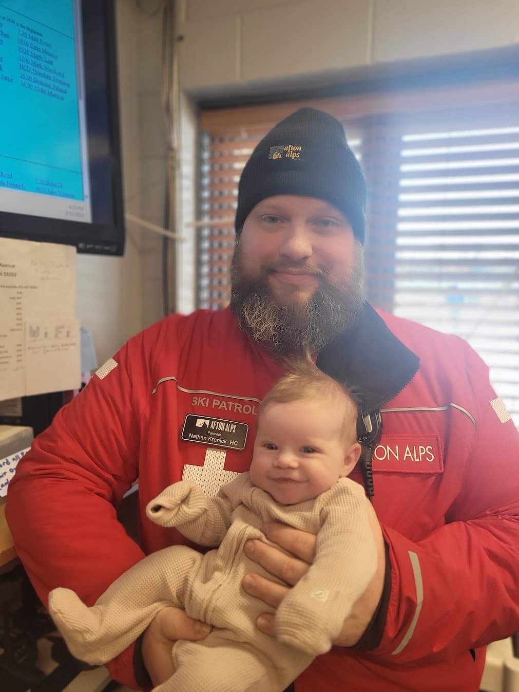 Nate on ski patrol at Afton Alps holding baby Freja