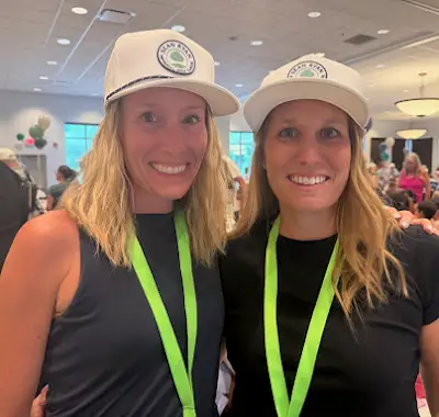 Two volunteers wearing event lanyards at the 2026 benefit dinner